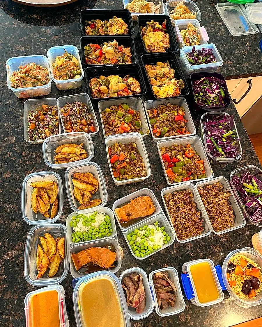 A real week of prepped meals in containers, made by Em